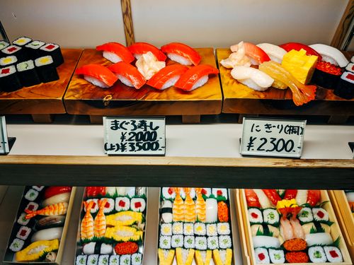 Free Variety of sushi and sashimi on display in a Japanese restaurant. Vibrant and enticing presentation. Stock Photo