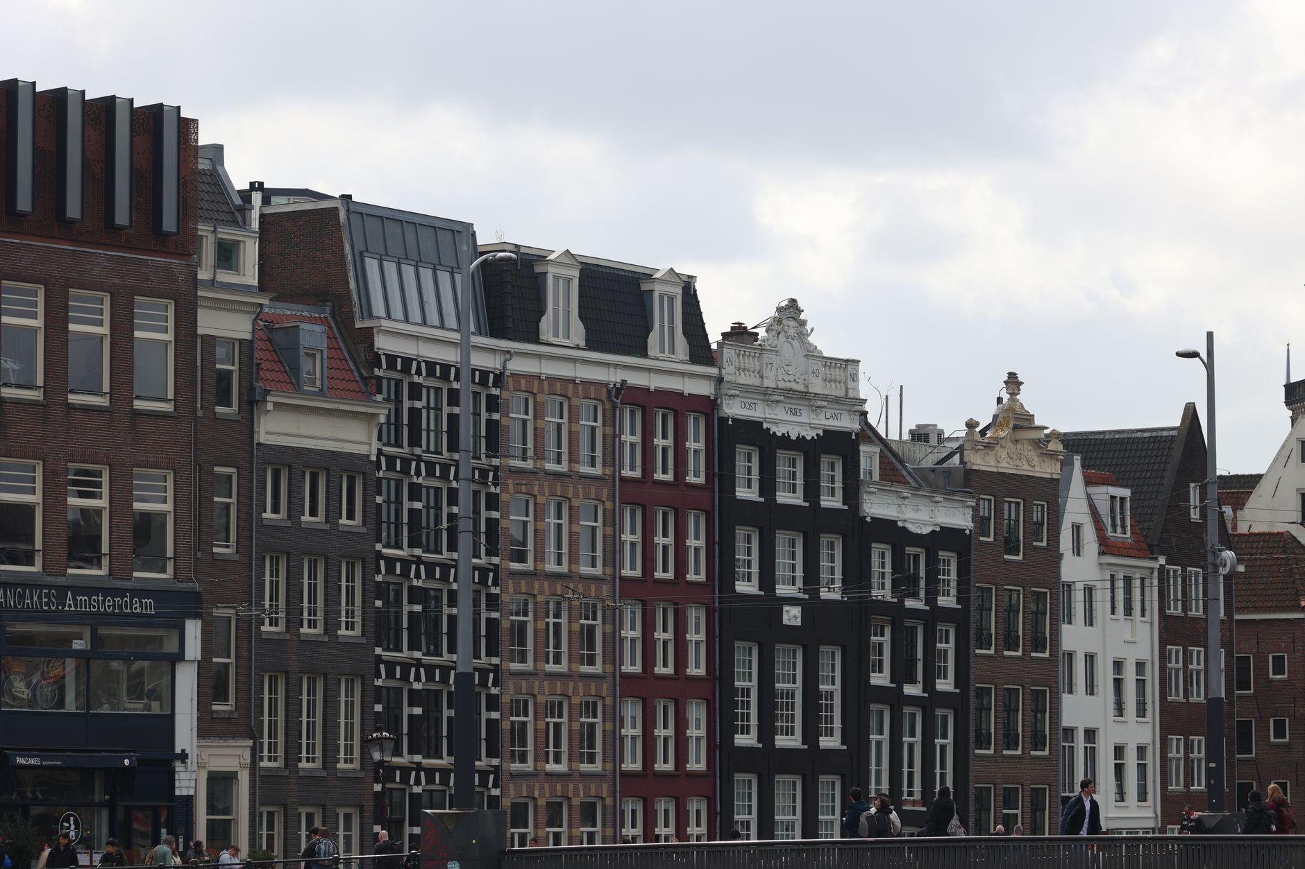 Quaint canal-side buildings in Amsterdam showcasing iconic Dutch architecture.