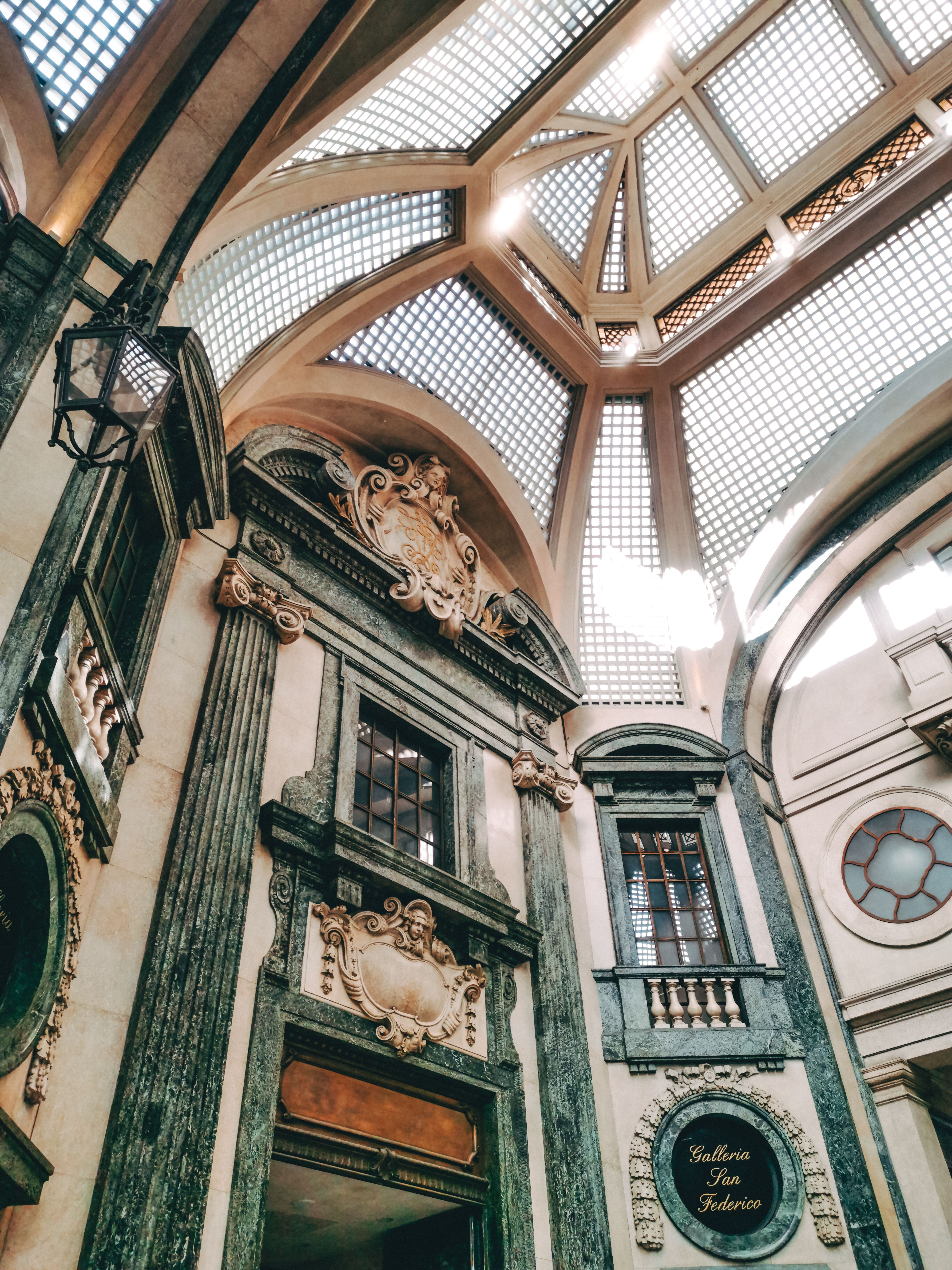 Intricate architectural design inside Galleria San Federico, showcasing classic Italian elements in Torino.