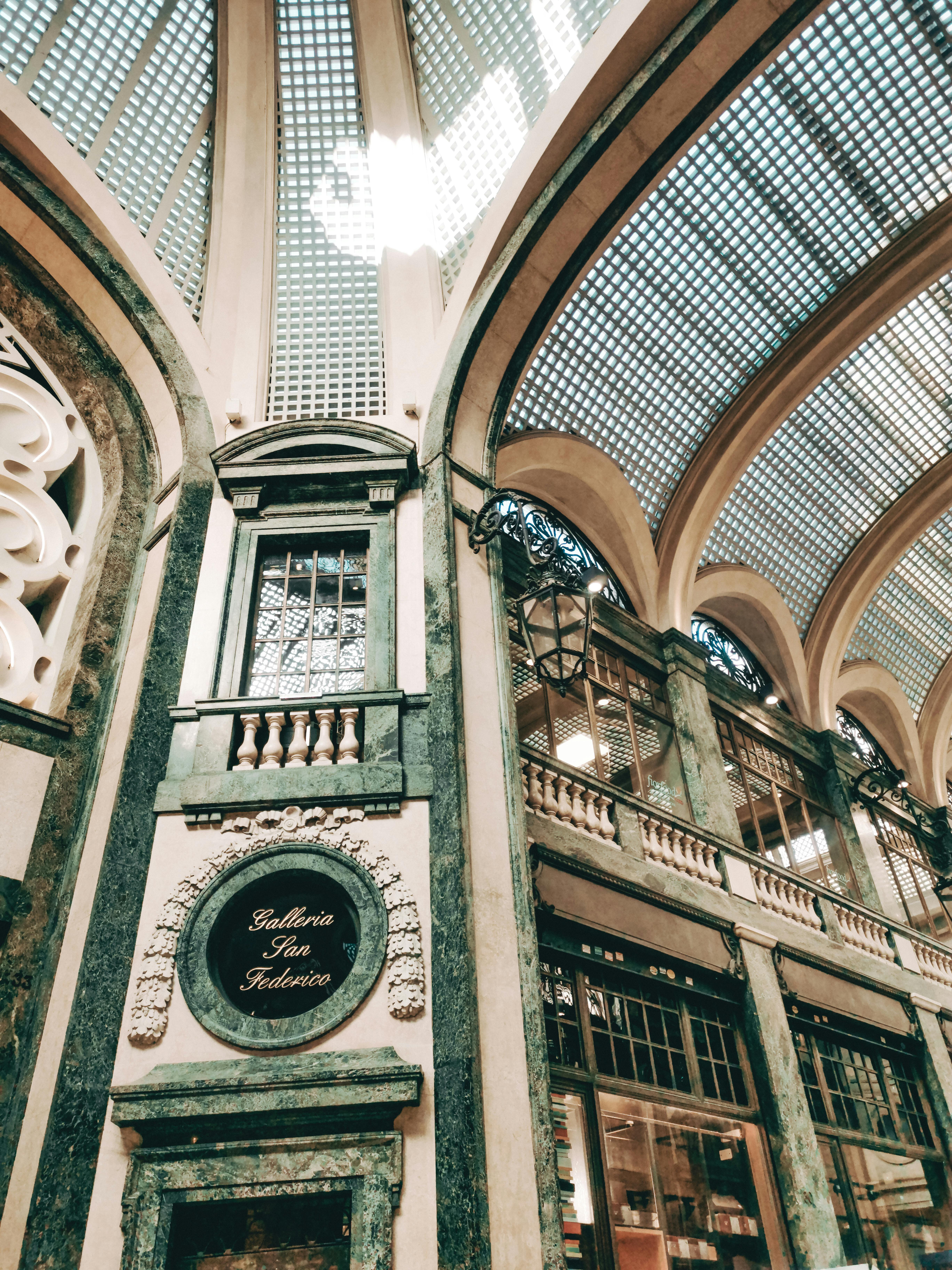 Stunning architectural design of the Galleria San Federico in Torino, Italy featuring a vaulted glass ceiling.