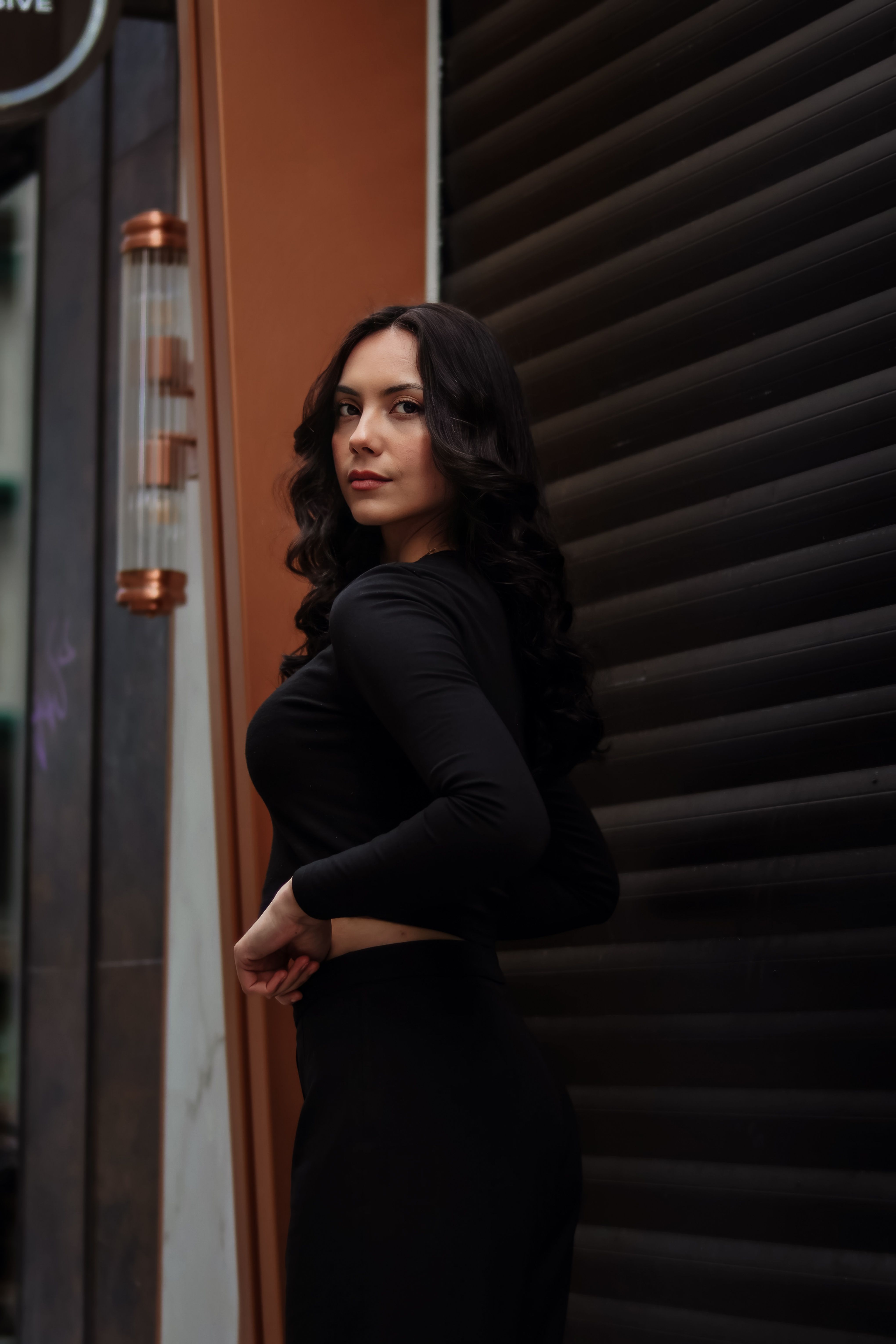 Stylish Woman Posing in Urban Street Setting · Free Stock Photo