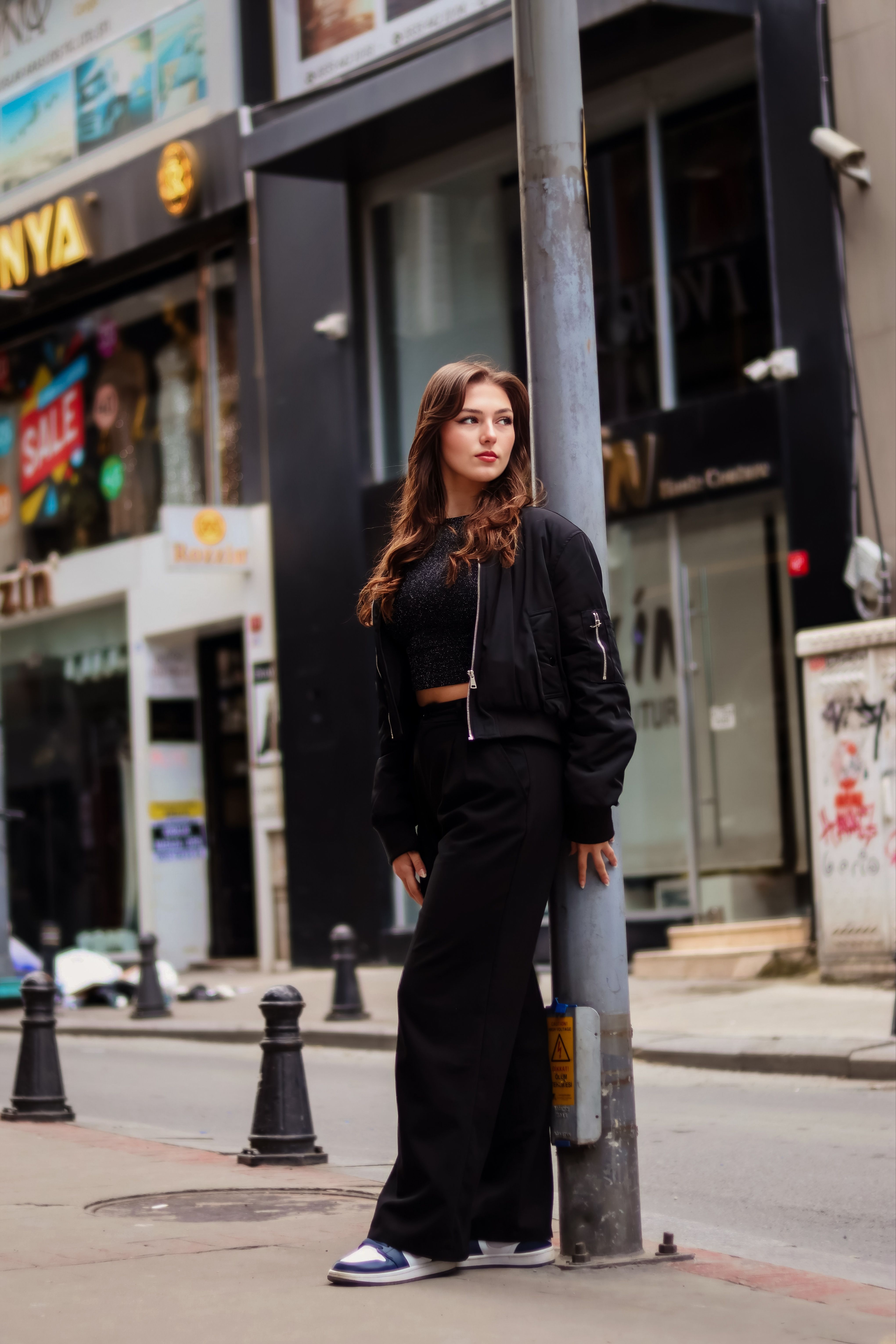 Stylish Woman Posing in Urban Street Setting · Free Stock Photo