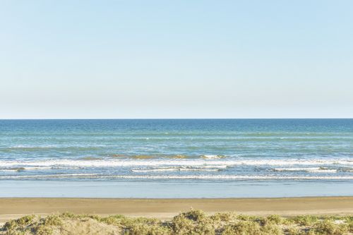 Free Experience the tranquil beauty of an Indonesian beach with clear blue waters and sandy shores. Stock Photo