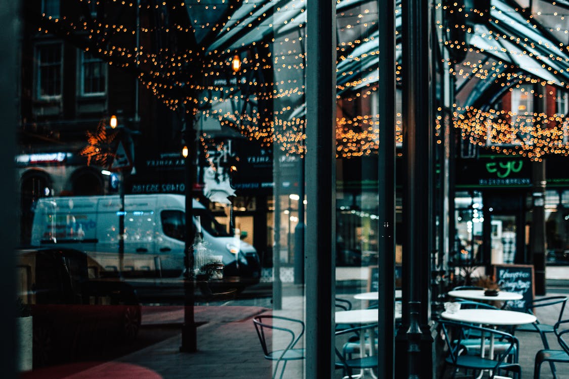 White Car Parked Near Glass Window