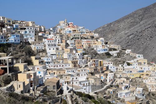 Free A scenic view of the pastel-colored houses on a mountain in a Greek village. Stock Photo