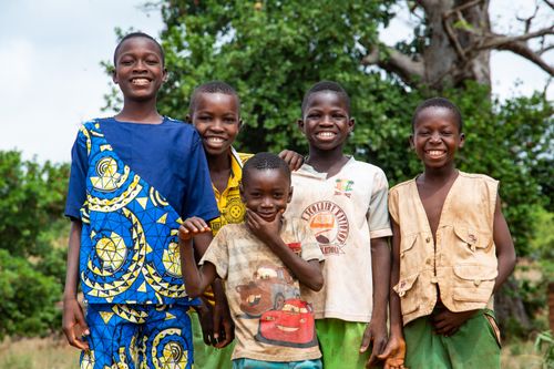 Free Group of happy African children smiling outdoors, conveying joy and friendship. Stock Photo
