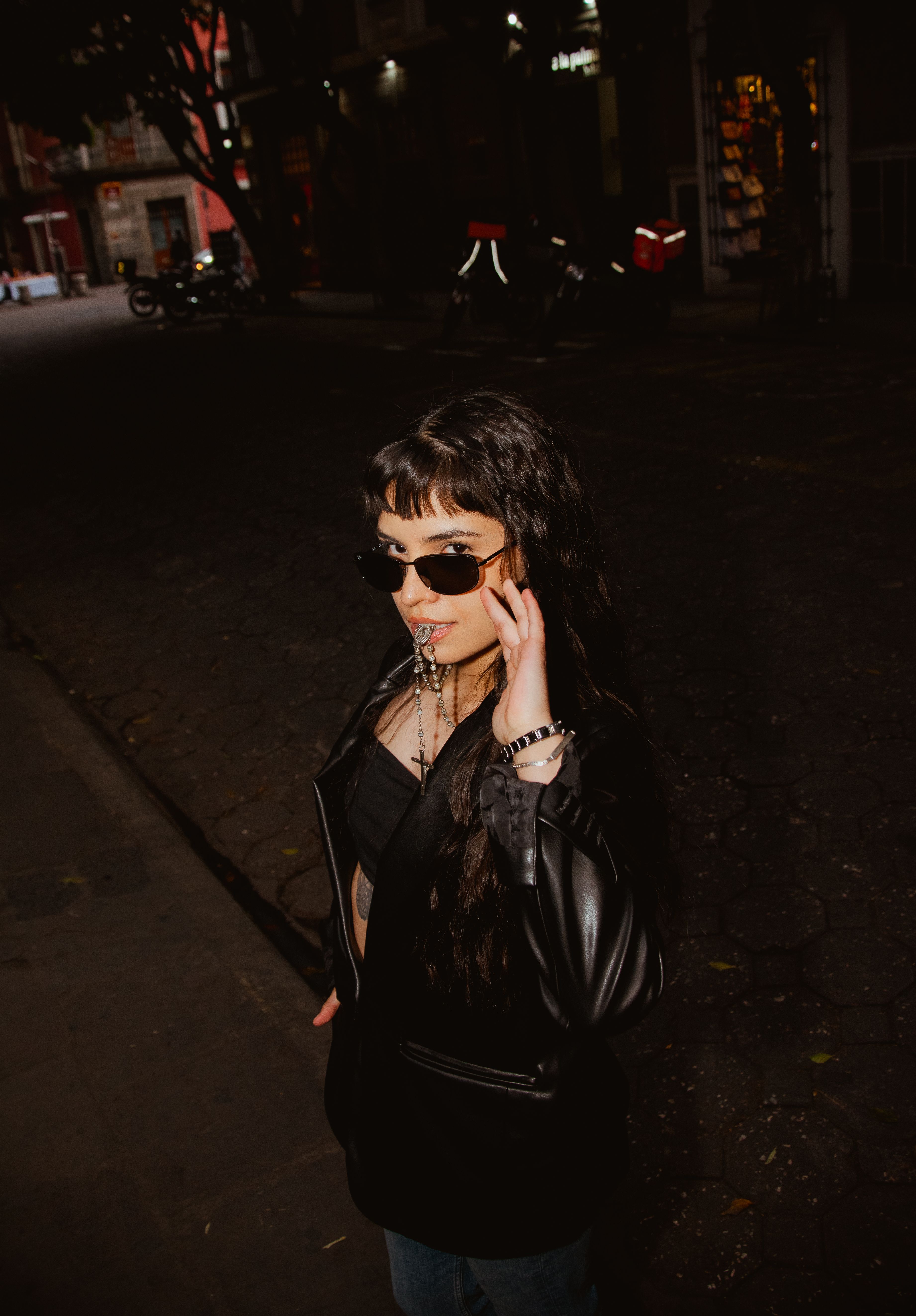 Stylish Woman in Black Outfit on City Street at Night · Free Stock Photo
