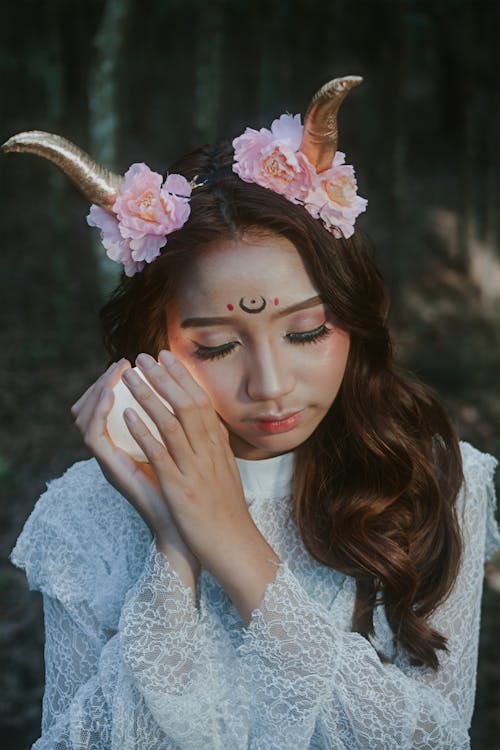 Woman in White Lace Long Sleeve Shirt With Pink Flower on Her Head