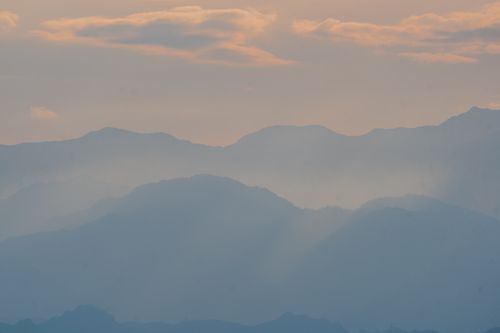 Free Tranquil view of layered mountains under a soft twilight sky, capturing nature's peaceful essence. Stock Photo
