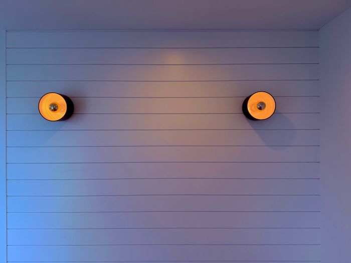 Two round sconces on a panelled wall — photo by Dar ius on Pexels
