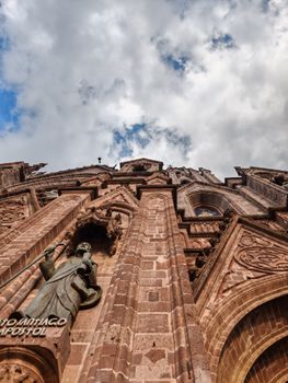 Stunning exterior view of Santiago Apóstol's Gothic architecture under a vibrant sky.
