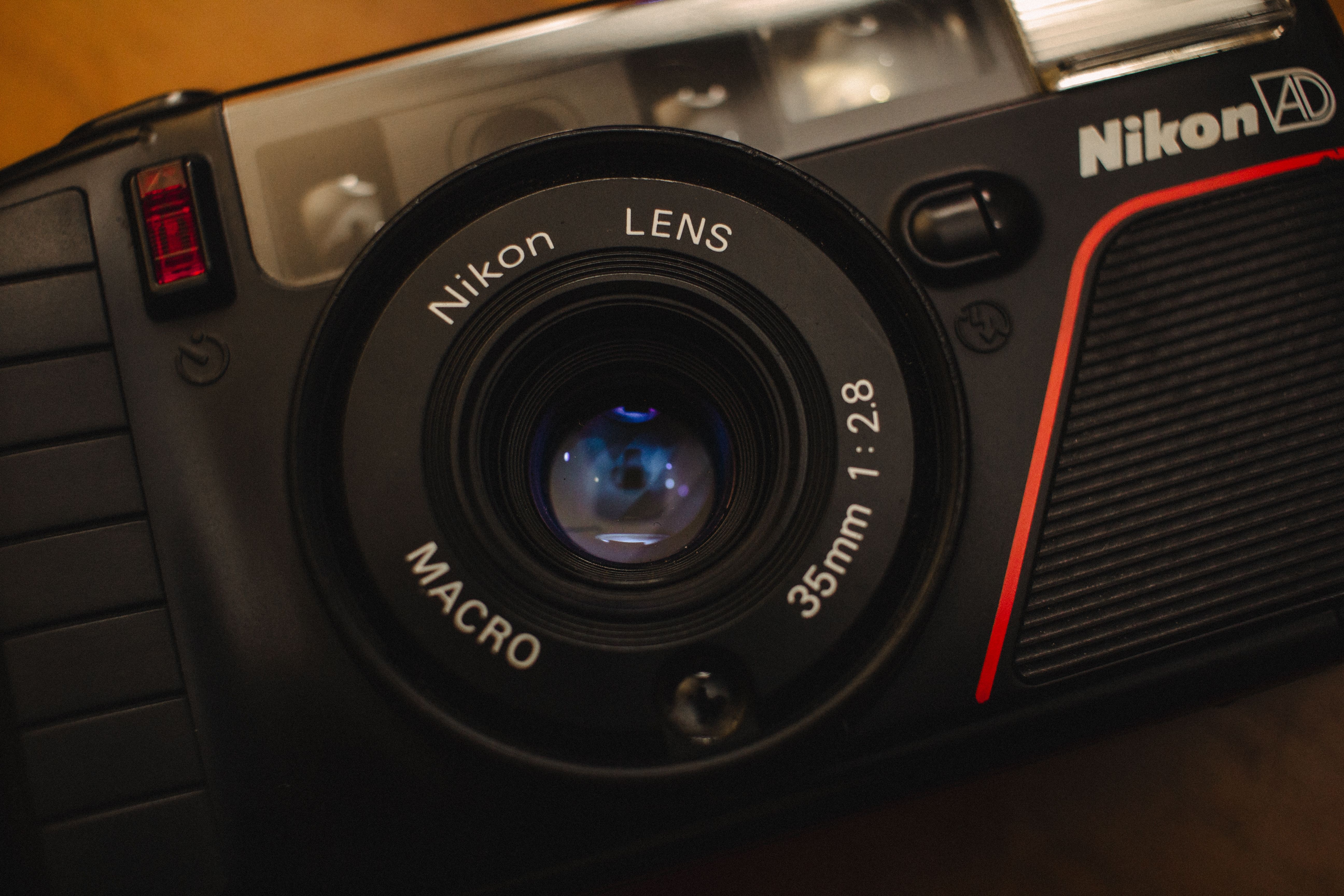 Close-up of a vintage Nikon camera featuring a Nikon lens with macro capability and 35mm focal length.