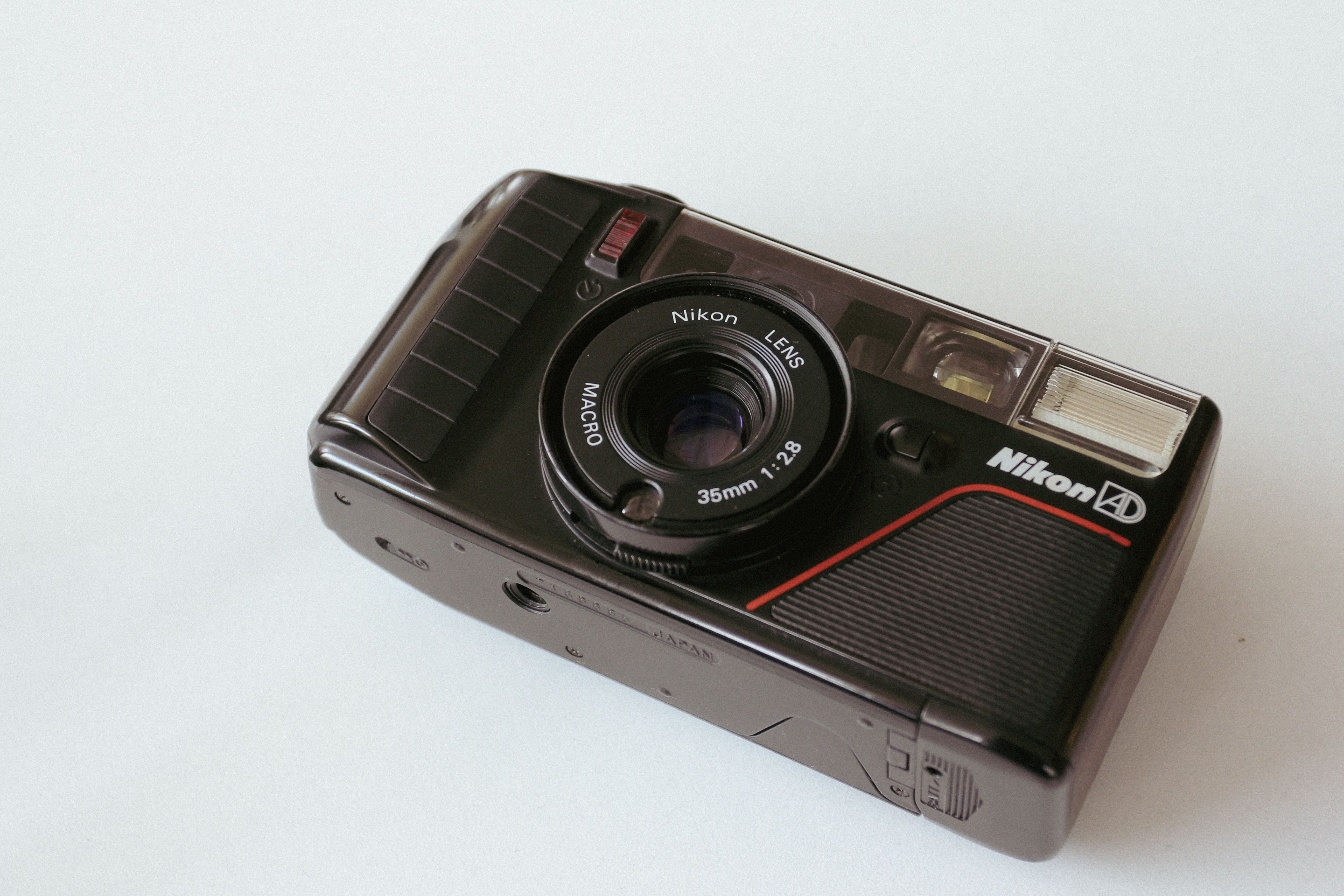 Classic Nikon film camera with lens and flash