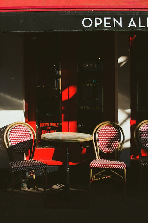 Wooden Round Table on Red Glass Window