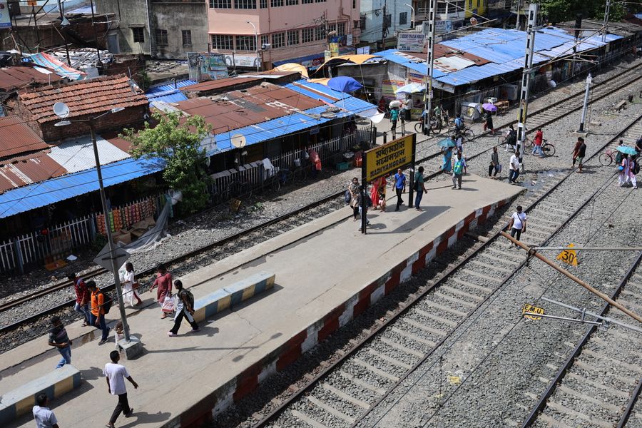Aerial view of people at Majherhat railway station platform in Kolkata, India.