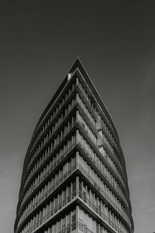 Free Striking grayscale photo of a modern building's facade with sharp angles. Stock Photo