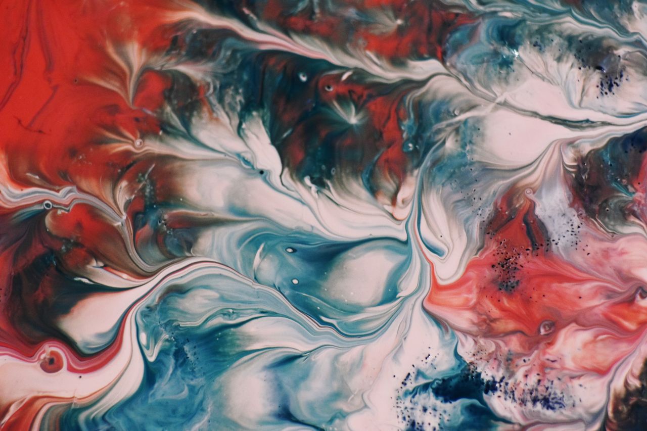 dynamic fluid painting with vibrant swirls of red blue and white showc