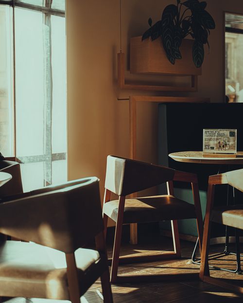 Free Warm, inviting café setting featuring wooden furniture and soft lighting. Stock Photo