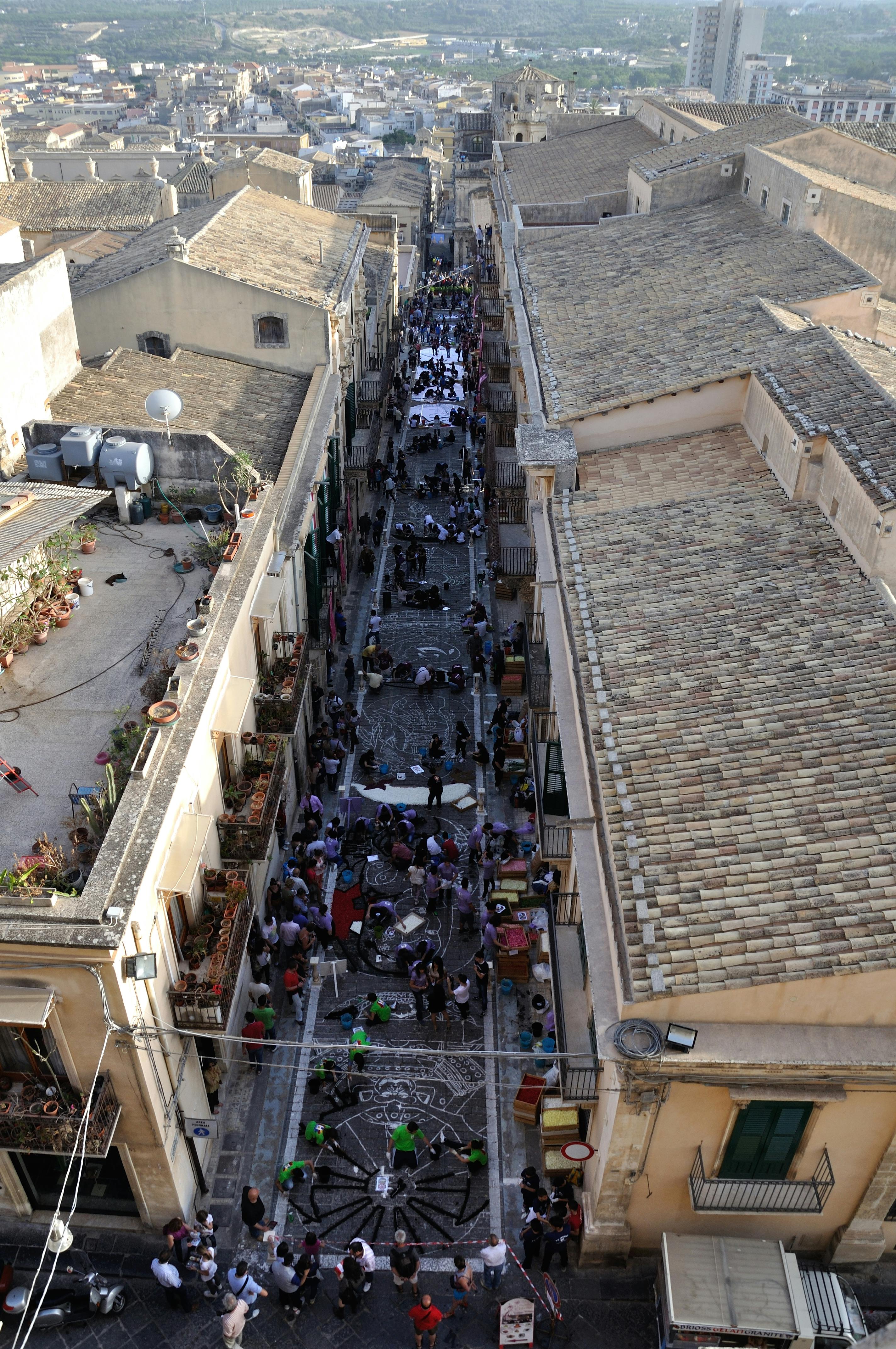 Colorful floral carpet during the Infiorata flower festival in Noto, Sicily, Italy.