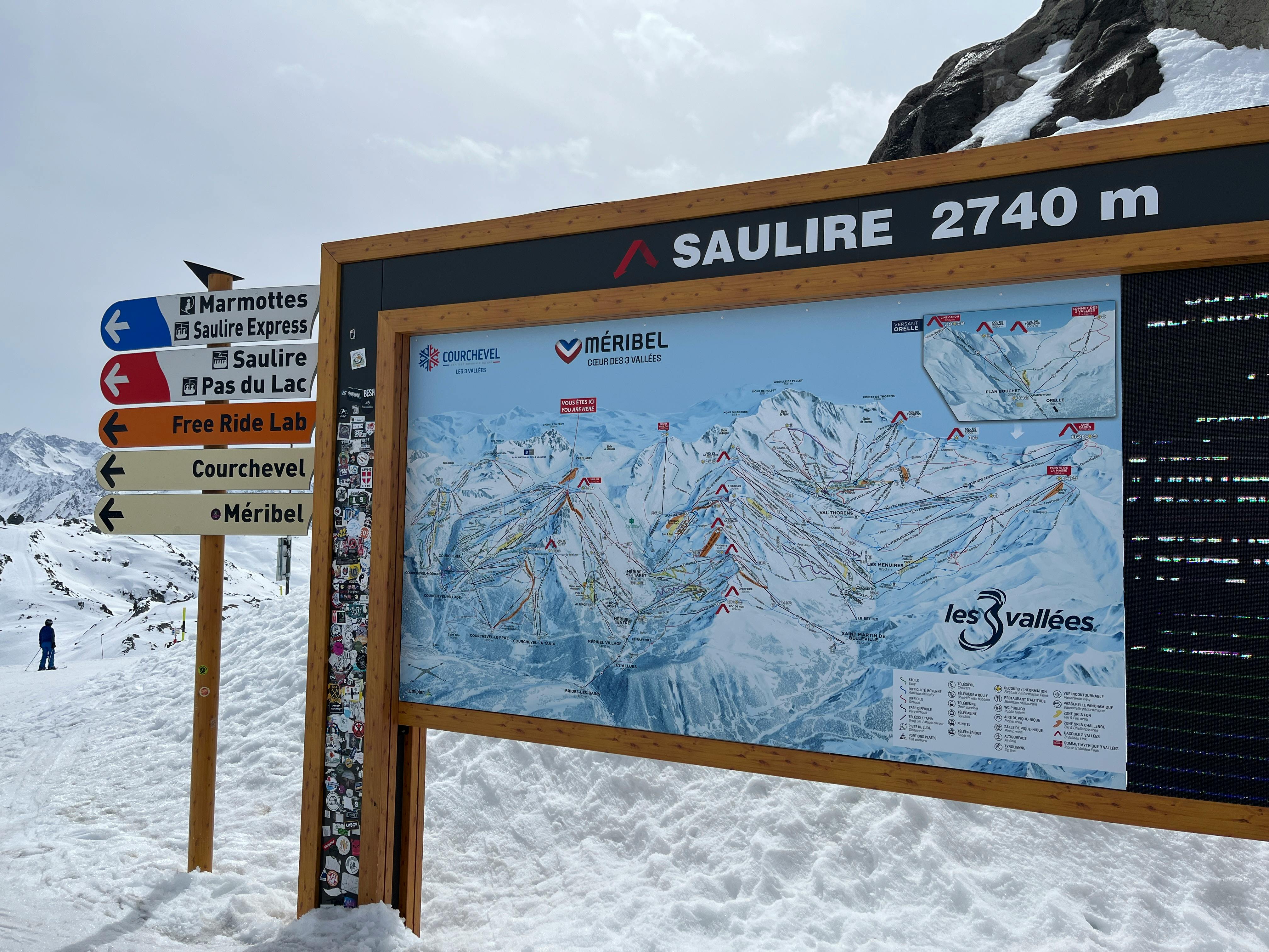 Ski map signage at Saulire summit in Les Allues, showcasing ski routes in Les Trois Vallées.