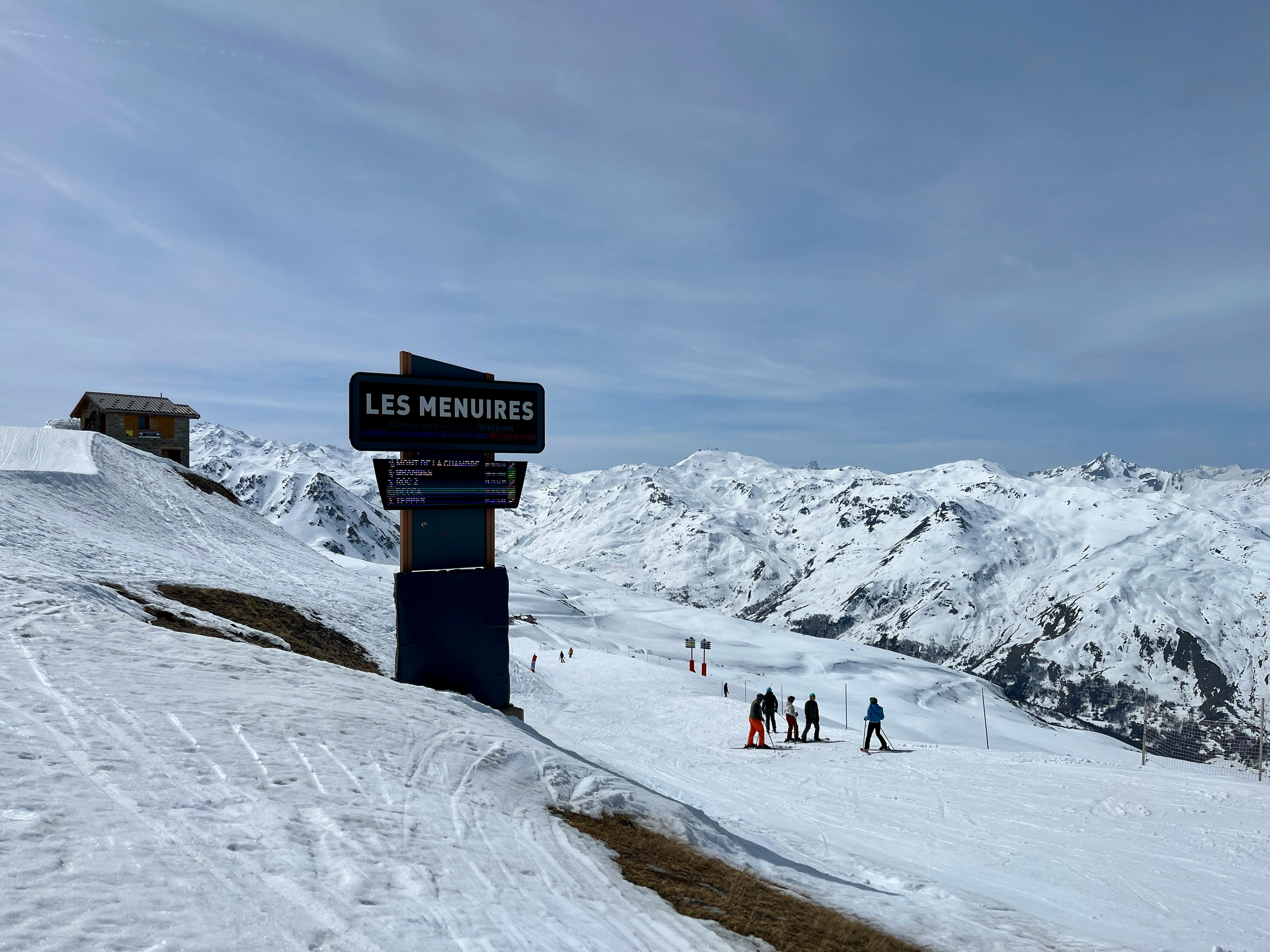 Scenic view of skiers at Les Menuires, a popular ski resort in the French Alps, during winter.