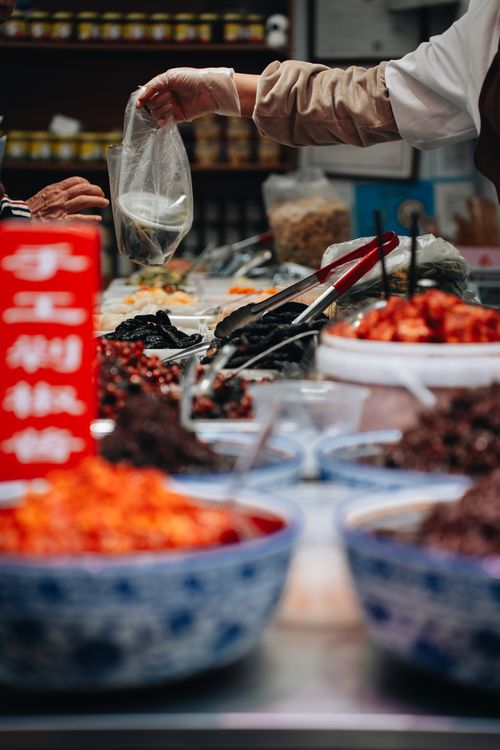 Free Colorful bowls of spices and ingredients at a bustling street food market in Shanghai. Stock Photo