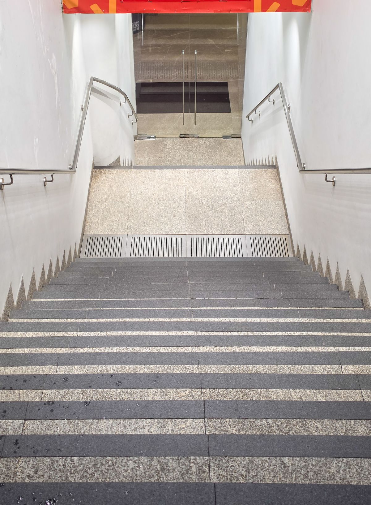 Indoor staircase with metal railings and a clear circulation path
