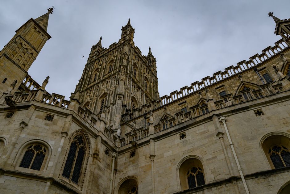 Stunning Gothic view of Gloucester Cathedral in England under a cloudy sky.