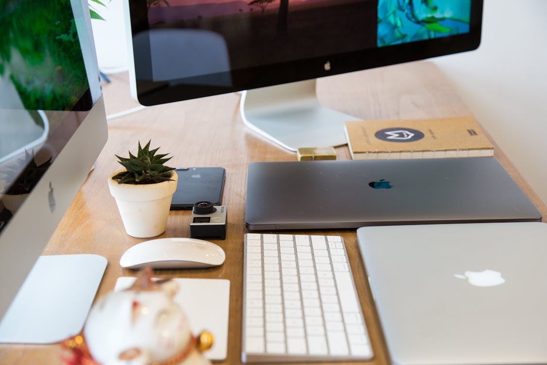 Free Windows Flat Screen Computer Monitor Beside Two Silver Macbooks Stock Photo