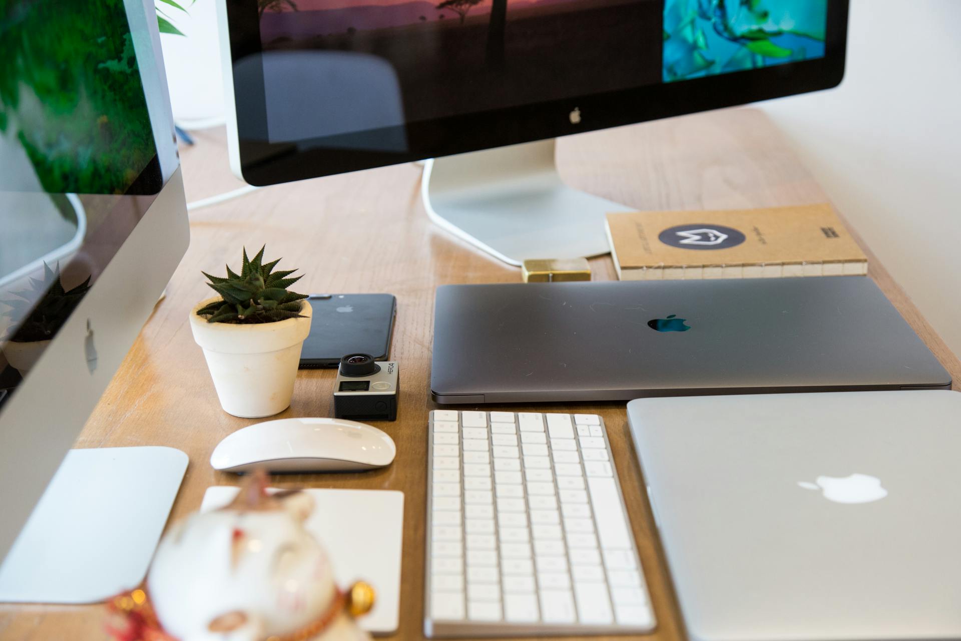 Windows Flat Screen Computer Monitor Beside Two Silver Macbooks