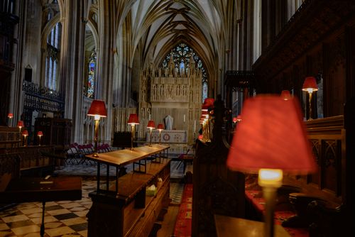 Free Stunning view of a cathedral's interior with vaulted ceilings and warm lighting. Stock Photo