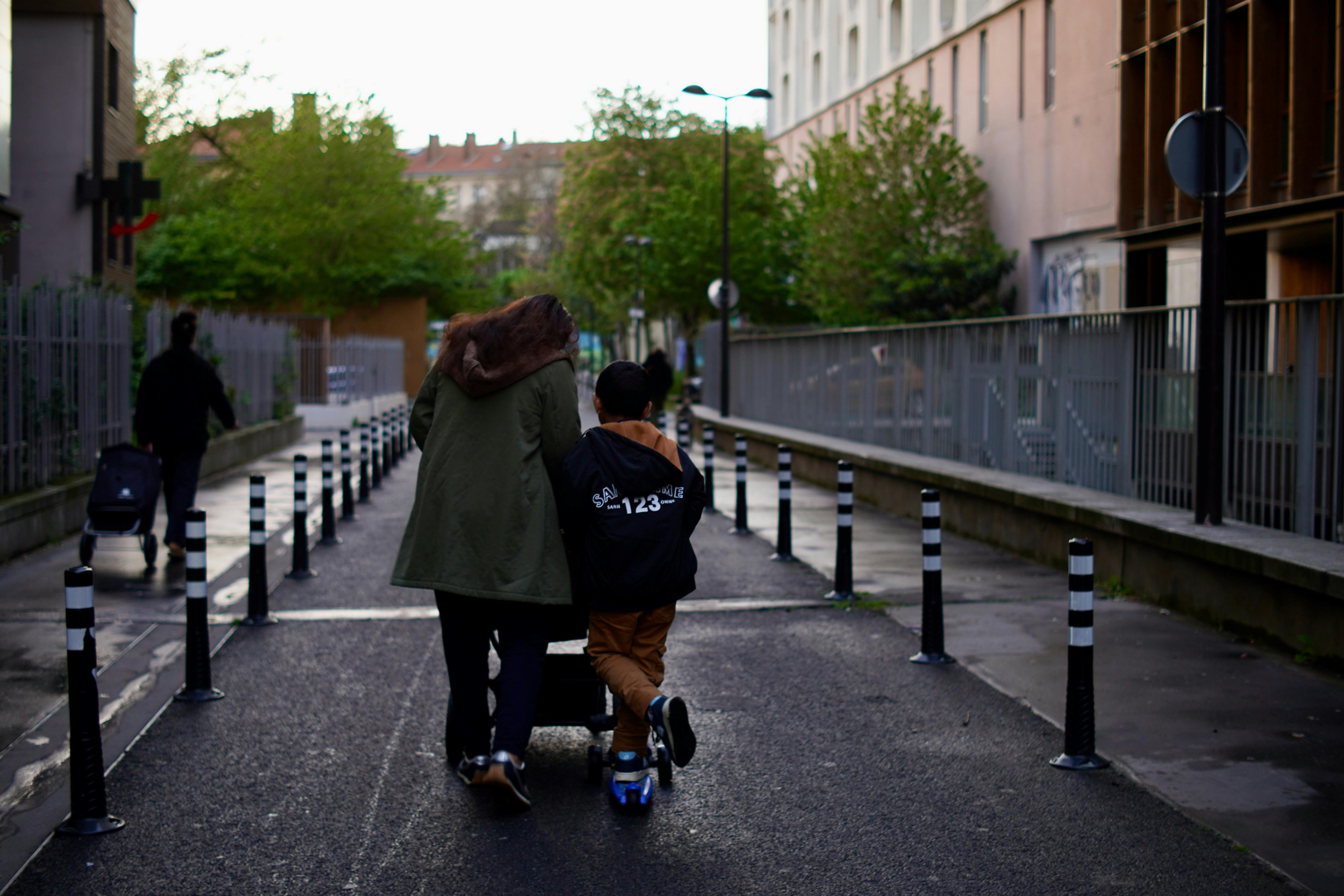 families walking together toward a large modern church building in an urban neighborhood