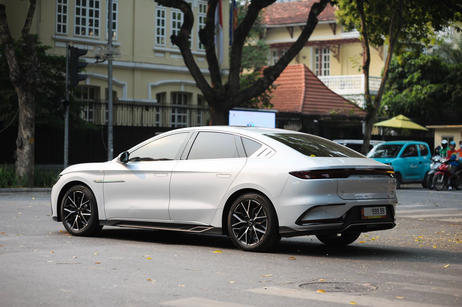 Electric car parked on a tree-lined street