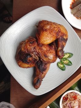 Delicious grilled chicken thighs paired with sliced green chilies for a spicy touch.