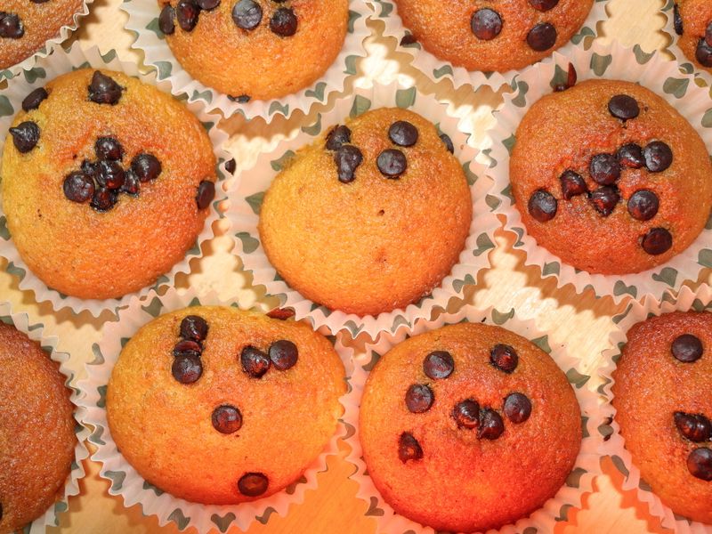 Delicious chocolate chip muffins arranged closely, highlighting texture and color.