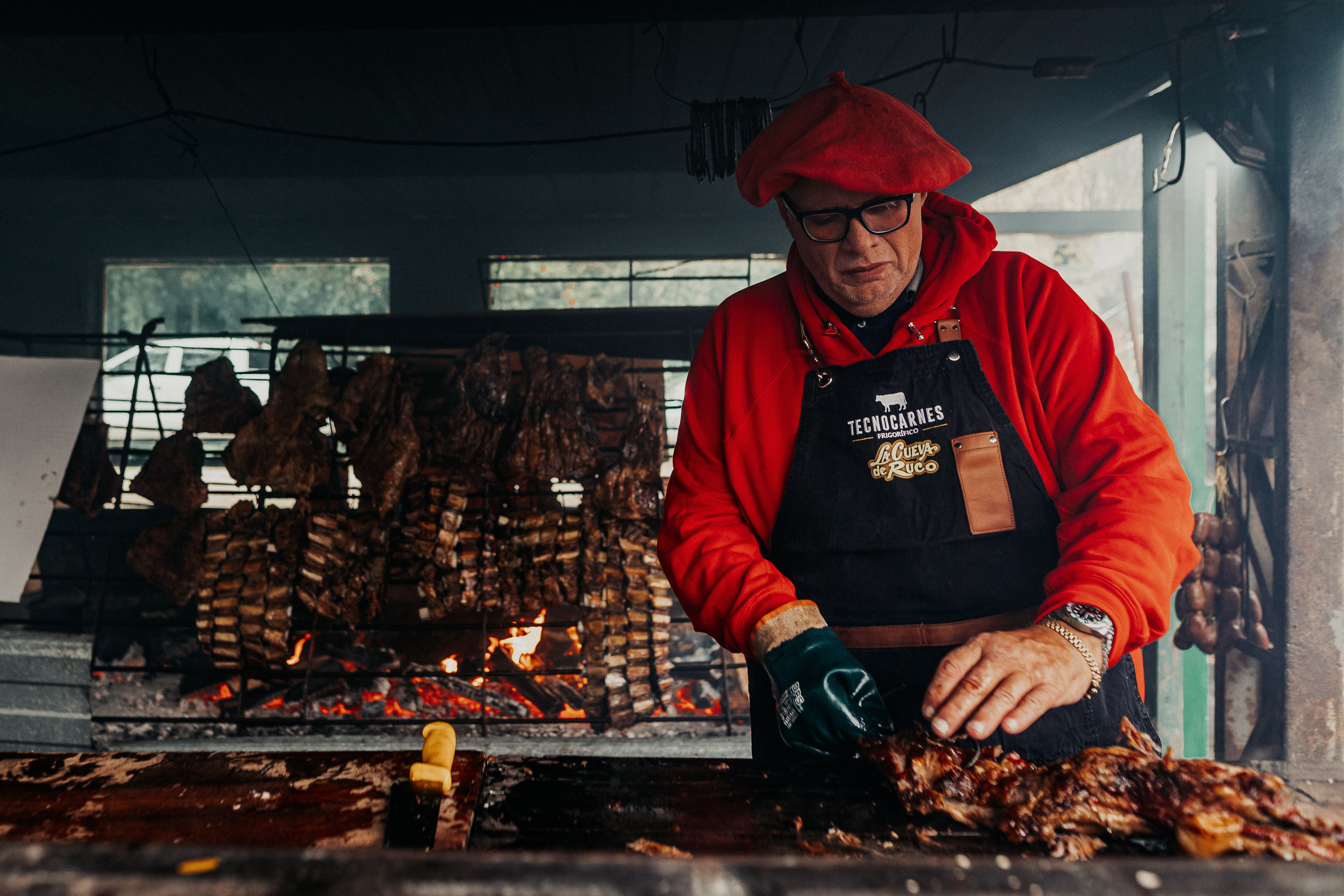 A chef prepares traditional Argentine asado in Buenos Aires, showcasing cultural culinary techniques.