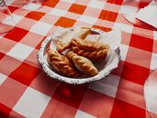 Savor the authentic taste of Argentine empanadas presented on a vibrant red checkered tablecloth.