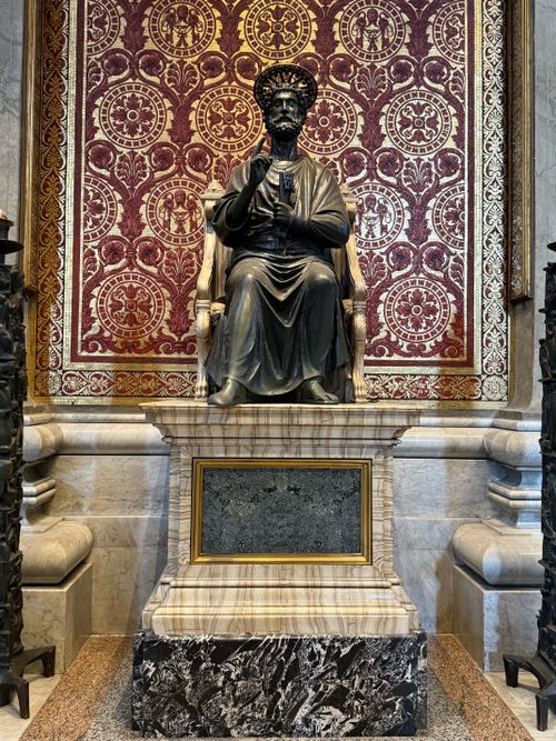Free Ornate Saint Peter statue inside Vatican City with elaborate backdrop. Stock Photo