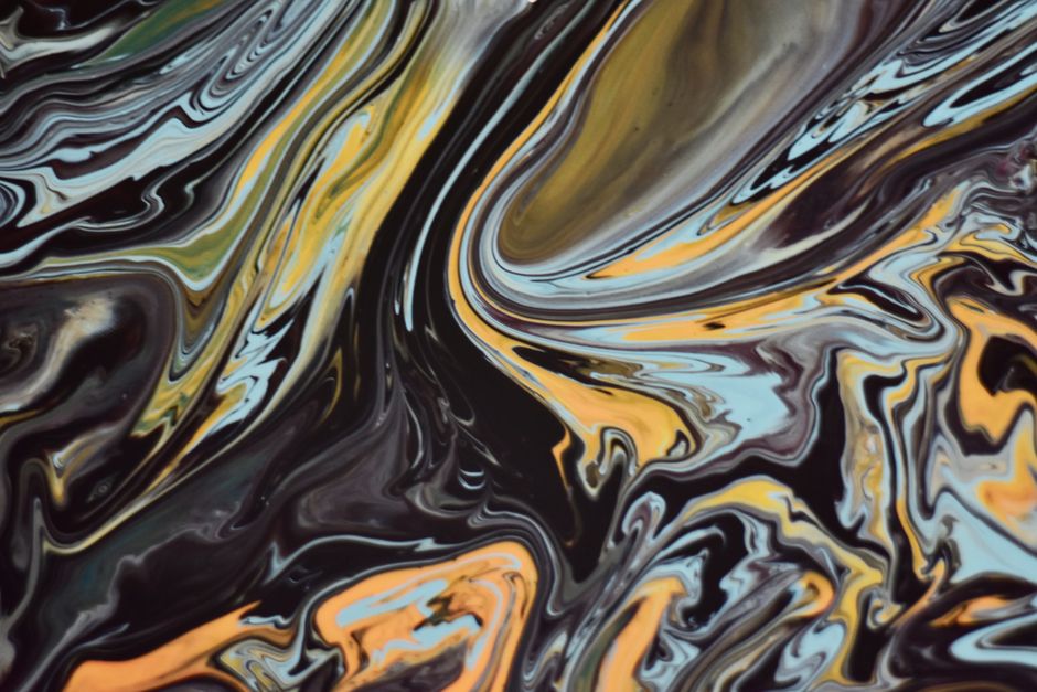 Vibrant abstract fluid art with dynamic swirling patterns and mixed colors.