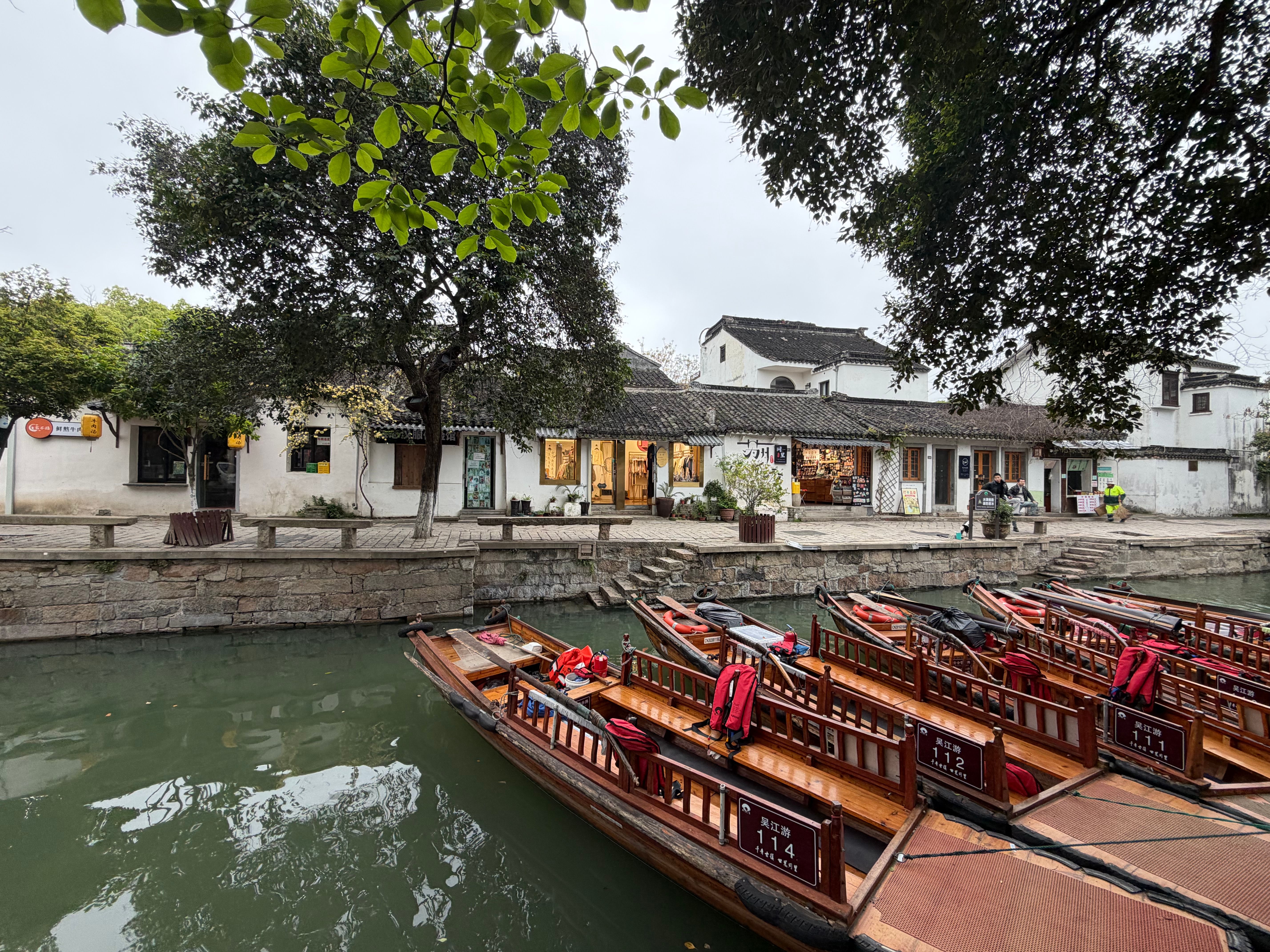 Traditional Chinese Riverside Village with Wooden Boats · Free Stock Photo