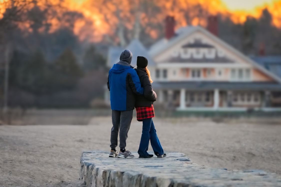 Couple Embracing on Beach at Sunset · Free Stock Photo