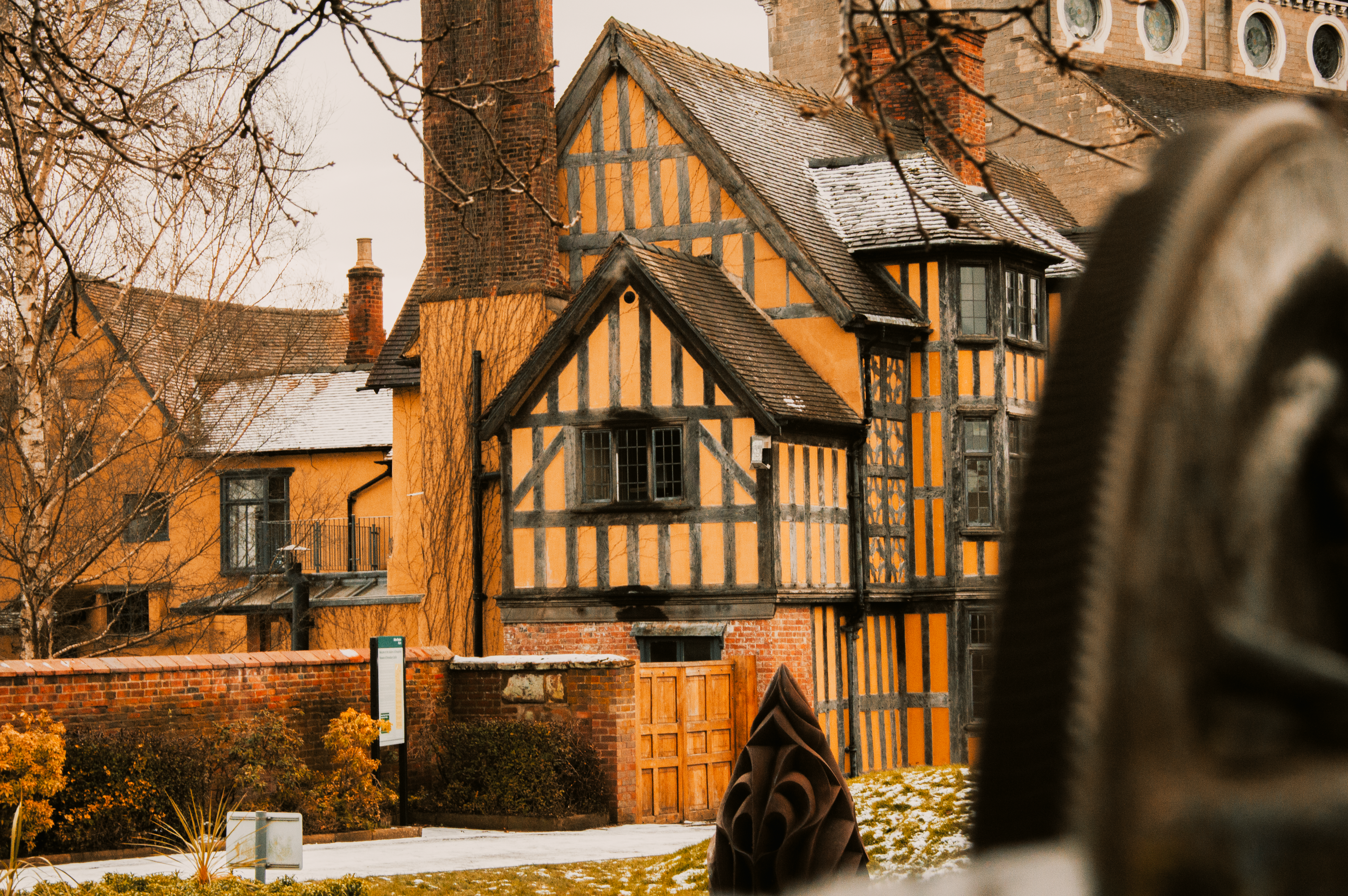 A picturesque view of historic Tudor-style buildings in snowy Shrewsbury, England.