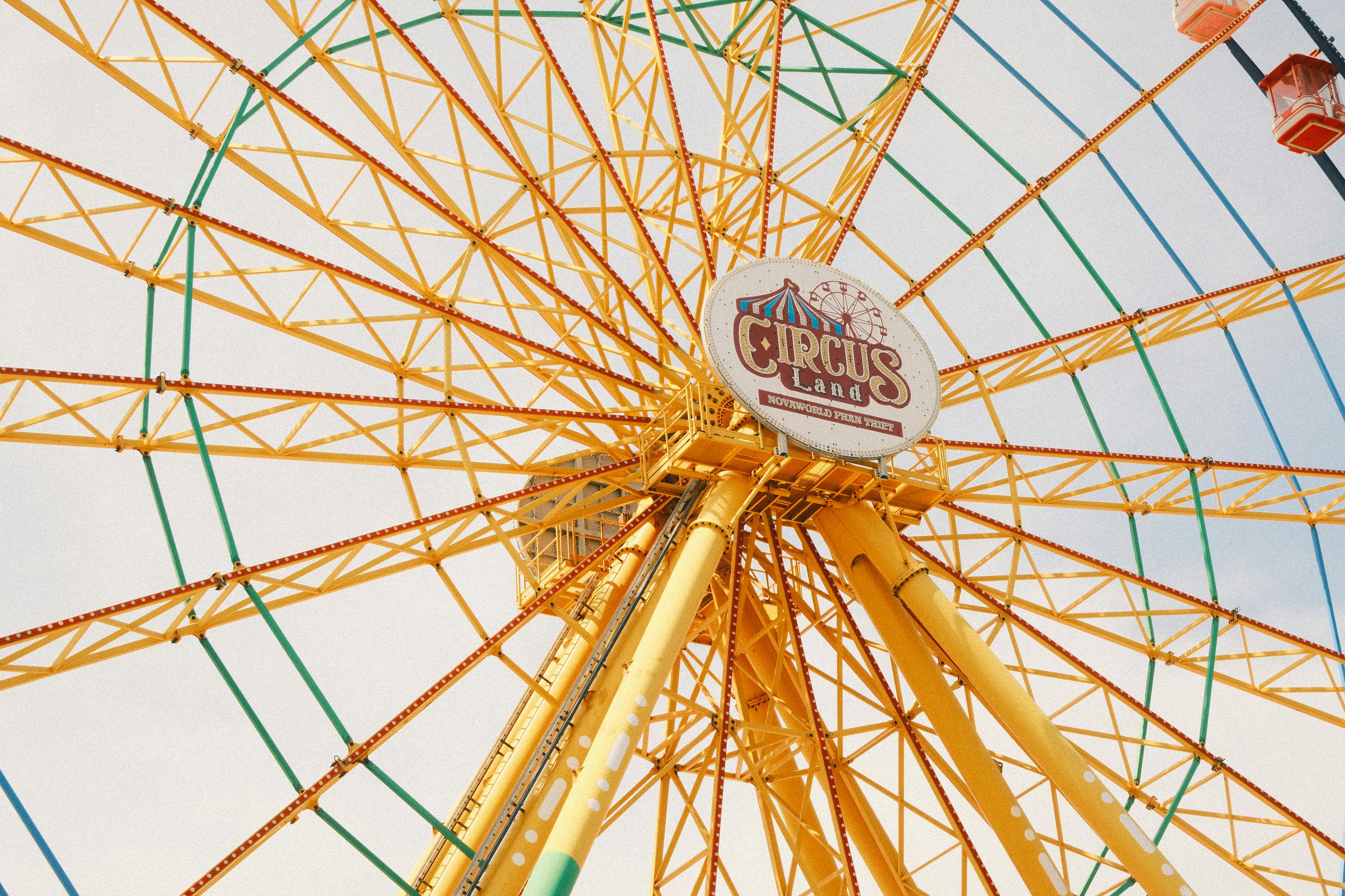 Bright yellow Ferris wheel at Circus Land amusement park, Phan Thiet, offering a vibrant and joyful experience.
