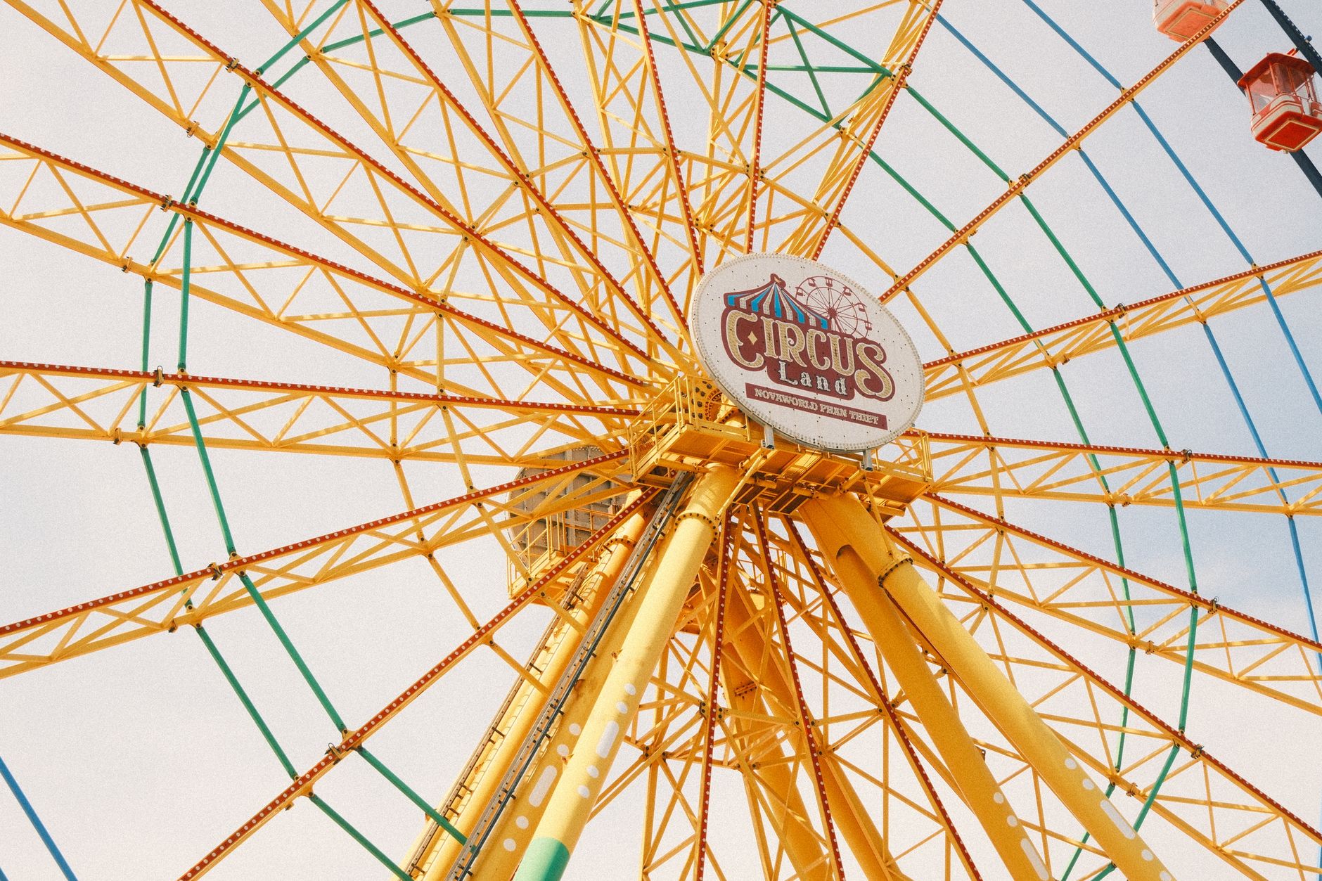 Bright yellow Ferris wheel at Circus Land amusement park, Phan Thiet, offering a vibrant and joyful experience.