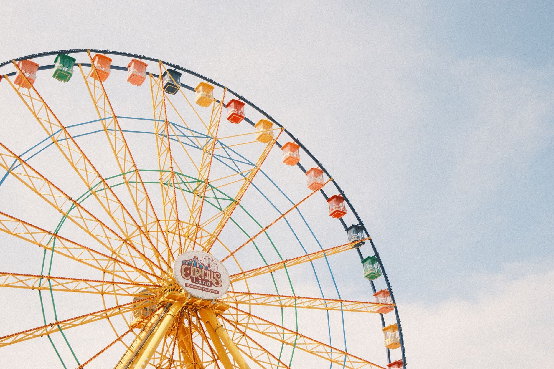 Bright Ferris wheel against a clear blue sky in Phan Thiet, Vietnam.