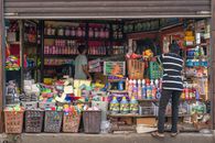 Vibrant street shop in Colombo selling cleaning products and household items.