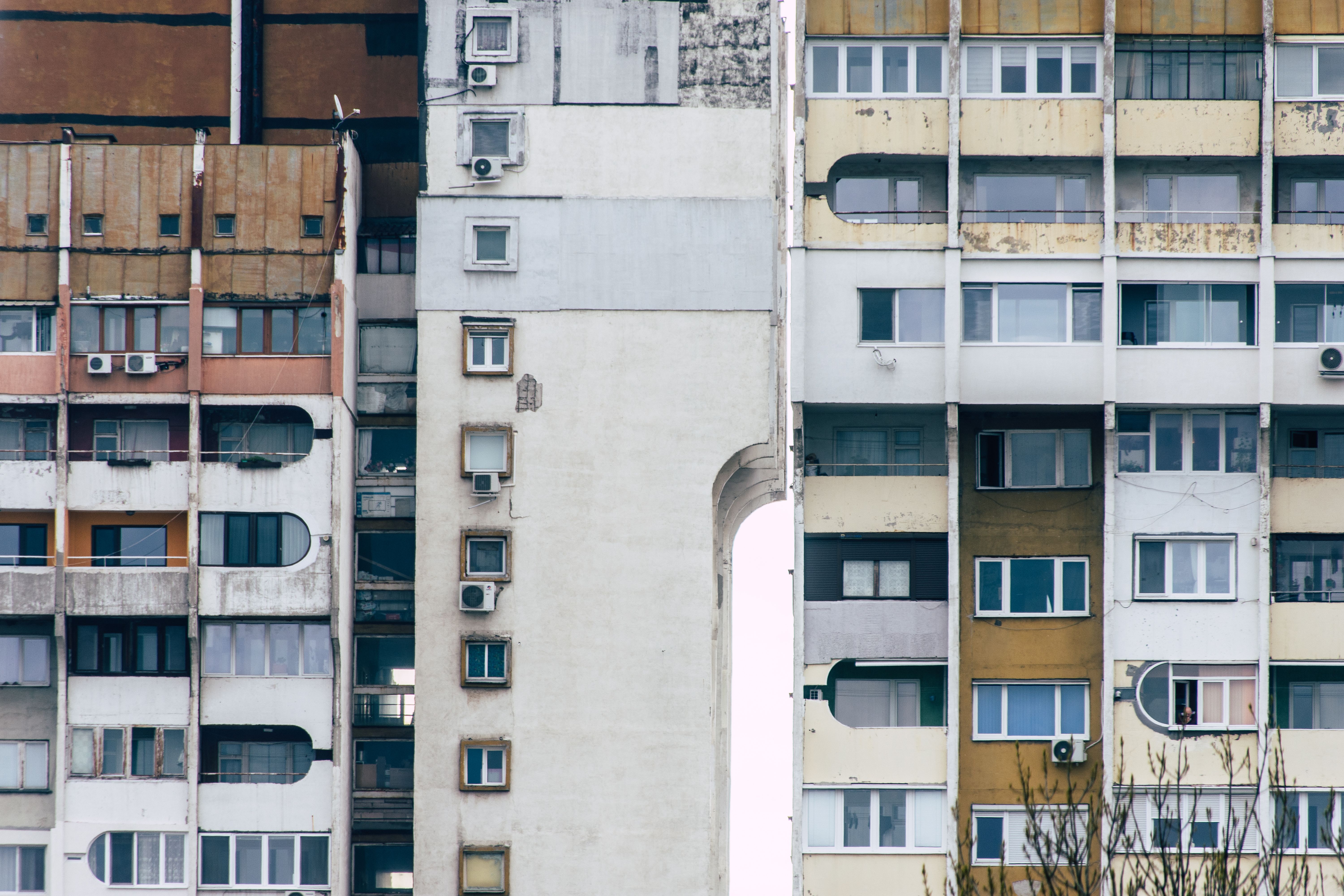 Detailed view of Soviet-style concrete apartment buildings with weathered facades and air conditioning units. — Trójmiasto