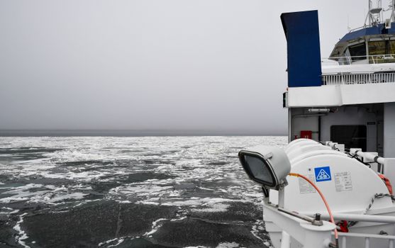 Ferry navigating through the icy waters of the Baltic Sea near Virtsu, Estonia.