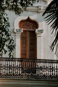 Elegant wooden shutters adorn a historical building's window in İzmit, Türkiye.