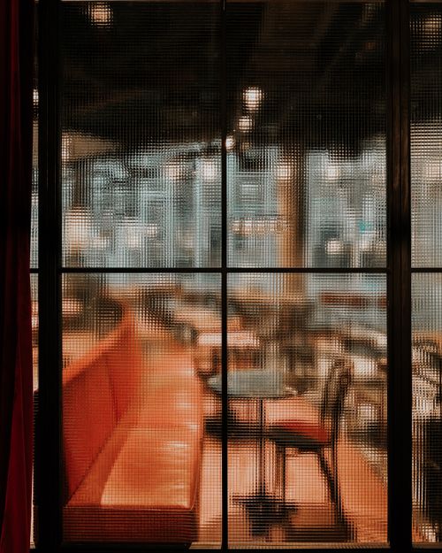 Free Warm and inviting Warsaw cafe interior with red seating and blurred glass partition. Stock Photo